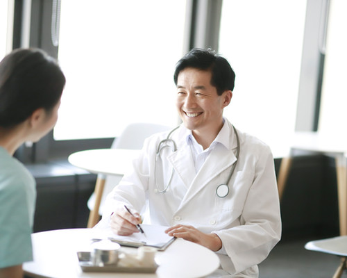 Independent physician talking with a patient in the practice
