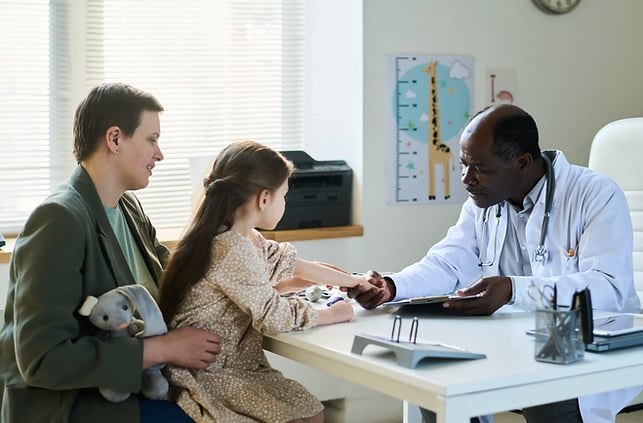 Doctor with patient and family