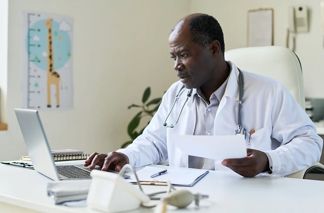 Doctor doing paperwork at desk