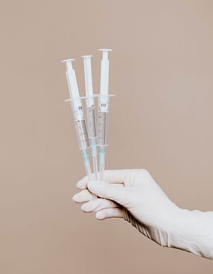 Hand holding syringes